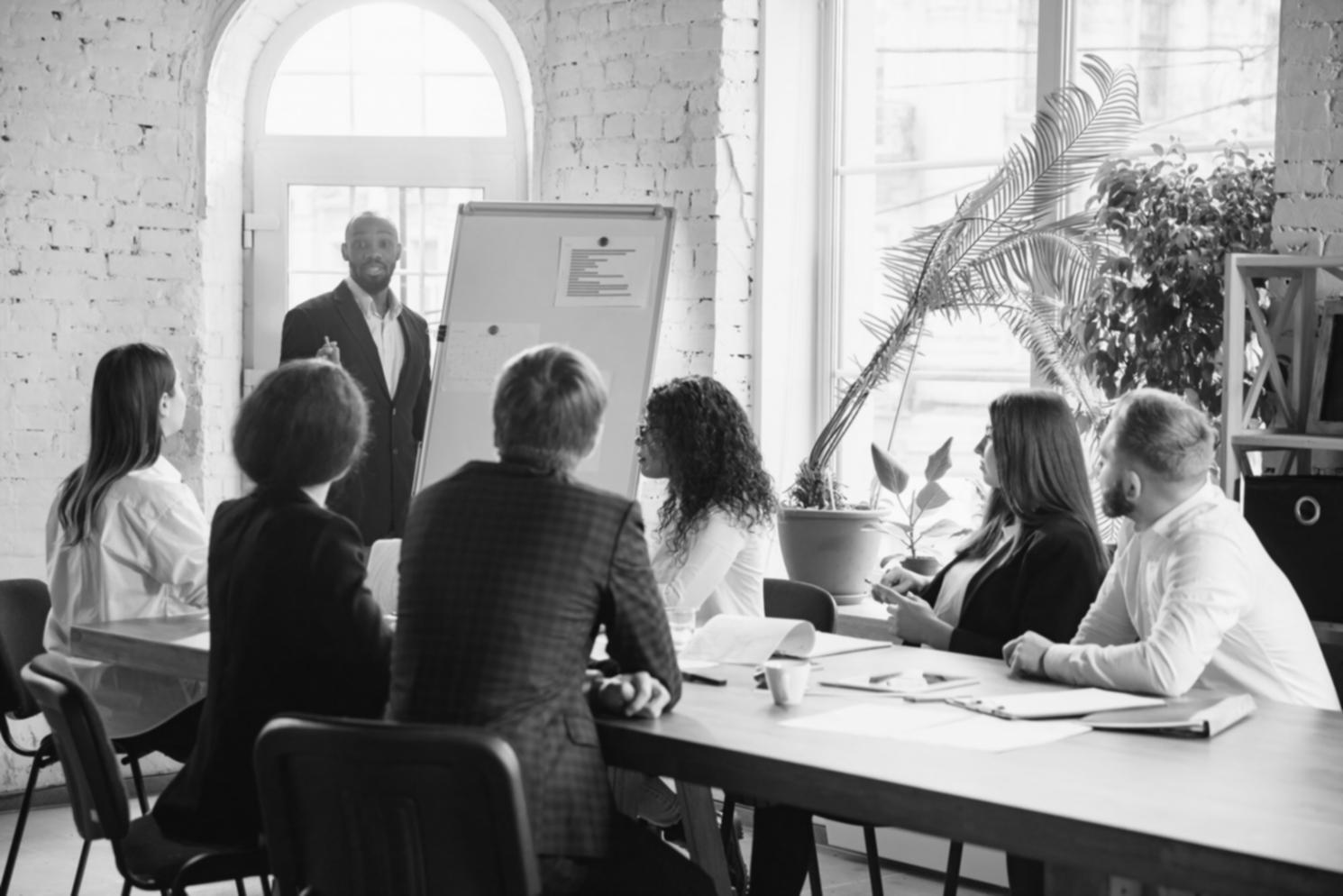 Professional presenting strategic business concepts to engaged audience